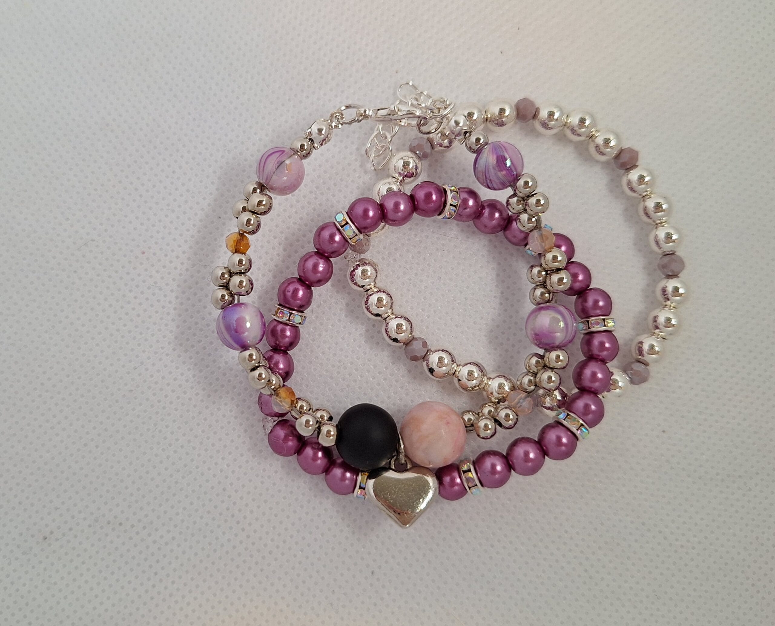 Set van 3 geluks- armbanden zilverkleurig/ paars, zilverkleurig, hart